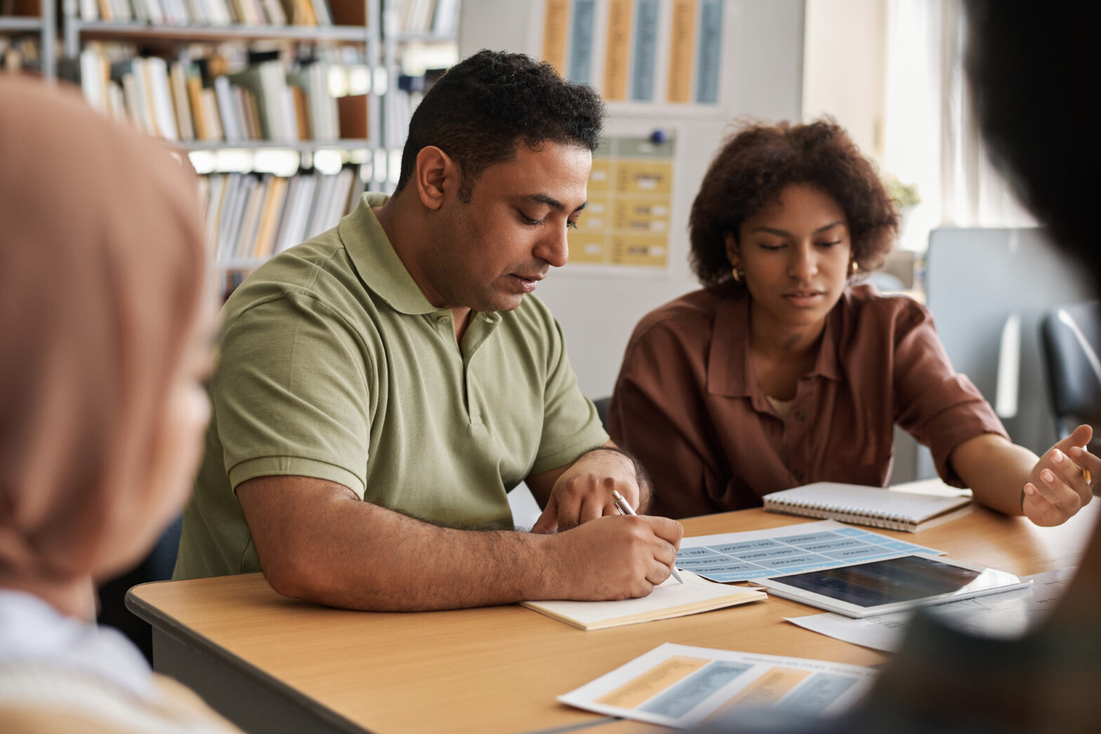Two adults talking over papers
